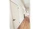 Clean and well-lit hallway with wood floors and white trim at 3355 Moorhead Ave, Boulder, CO 80305