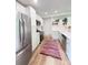 Bright kitchen featuring stainless steel appliances, white cabinetry, and modern countertops at 3355 Moorhead Ave, Boulder, CO 80305
