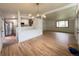 Spacious living room with a view into the updated kitchen, and features hardwood floors at 3355 Moorhead Ave, Boulder, CO 80305
