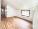 Bright living room featuring beautiful hardwood floors and a large window at 3355 Moorhead Ave, Boulder, CO 80305