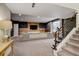 Large basement with carpet, wooden decor, a gray sofa, and a workout machine at 629 Jackson St, Lafayette, CO 80026