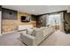 Spacious basement featuring a comfortable sectional sofa, TV, and rustic wooden accents at 629 Jackson St, Lafayette, CO 80026