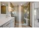 Modern bathroom featuring a double vanity, elegant lighting, and a glass-enclosed shower with built-in bench at 629 Jackson St, Lafayette, CO 80026