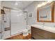 Modern bathroom with a glass-enclosed shower, wood vanity, and stylish fixtures at 629 Jackson St, Lafayette, CO 80026