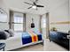 Bedroom features a bed, two windows, a dresser, and an electric guitar on the wall at 629 Jackson St, Lafayette, CO 80026