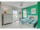 Bedroom features a bed, dresser, and a bright green accent wall at 629 Jackson St, Lafayette, CO 80026
