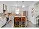 Bright kitchen with white cabinetry, stainless steel appliances, a center island, and stylish backsplash at 629 Jackson St, Lafayette, CO 80026