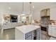 Modern kitchen featuring a center island with seating, stainless steel appliances, and stylish backsplash at 629 Jackson St, Lafayette, CO 80026
