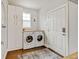 Efficient laundry room with modern washer, dryer, ample storage, and a functional design at 629 Jackson St, Lafayette, CO 80026