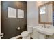 Chic powder room featuring a pedestal sink, decorative mirror, and stylish fixtures at 629 Jackson St, Lafayette, CO 80026