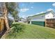 Expansive backyard with lush green lawn, a detached garage, and mature trees, ideal for outdoor living at 130 N 8Th Ave, Brighton, CO 80601