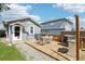 Inviting backyard showcasing a wooden deck, a grill, and a well-maintained lawn, ideal for relaxing and entertaining at 130 N 8Th Ave, Brighton, CO 80601