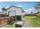 Backyard with a detached garage featuring a roll-up door, and secure fencing at 130 N 8Th Ave, Brighton, CO 80601