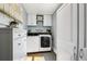 Bright laundry room with new washer and dryer, plus storage cabinets and a dresser at 130 N 8Th Ave, Brighton, CO 80601
