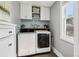 Well-equipped laundry room with front loading machines, white cabinets, and folding space at 130 N 8Th Ave, Brighton, CO 80601