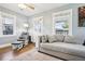 Inviting living room with a gray rocking chair, large sofa, and ample natural light, creating a welcoming atmosphere at 130 N 8Th Ave, Brighton, CO 80601