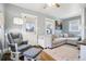 Comfortable living room with a gray sectional, plush rug, and a cozy rocking chair, perfect for relaxing at 130 N 8Th Ave, Brighton, CO 80601
