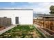 A modern home showcasing a minimalist backyard with wooden fencing and planter boxes at 2685 S Acoma St, Denver, CO 80223