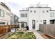 A modern home featuring a cozy backyard with a patio, pergola, hot tub, and minimalist landscaping at 2685 S Acoma St, Denver, CO 80223