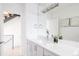 Bright bathroom with a large mirror, modern sink, and stairs in view at 2685 S Acoma St, Denver, CO 80223