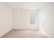 Bright and airy bedroom featuring neutral carpet, white walls, and a window at 2685 S Acoma St, Denver, CO 80223