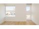 Bright bedroom with hardwood floors and multiple windows at 2685 S Acoma St, Denver, CO 80223