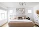 Bright bedroom featuring a chandelier, modern art, and neutral tones at 2685 S Acoma St, Denver, CO 80223