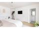 Bright bedroom with a chandelier, television, and view of the stairs and bathroom at 2685 S Acoma St, Denver, CO 80223