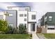 Modern home with gray and white facade, manicured lawn, and inviting entryway at 2685 S Acoma St, Denver, CO 80223