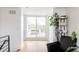 Bright hallway with wood floors leading to a deck with an outdoor dining area and sliding glass doors at 2685 S Acoma St, Denver, CO 80223