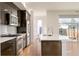 Modern kitchen with stainless steel appliances, sleek dark cabinets, and bright white countertop island at 2685 S Acoma St, Denver, CO 80223