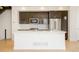 Bright kitchen island featuring white countertop, modern appliances, and sleek dark cabinetry at 2685 S Acoma St, Denver, CO 80223