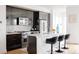 Contemporary kitchen featuring sleek dark cabinetry, stainless steel appliances, and white countertops at 2685 S Acoma St, Denver, CO 80223