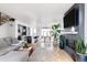 Inviting living area featuring a fireplace, comfortable seating, modern kitchen, and hardwood floors at 2685 S Acoma St, Denver, CO 80223