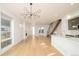 Stylish living area with an open staircase, hardwood floors, modern chandelier, and great natural light at 2685 S Acoma St, Denver, CO 80223