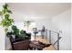 Upstairs office featuring hardwood floors, a modern desk, large windows, and decorative plants at 2685 S Acoma St, Denver, CO 80223