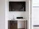 Stylish modern wet bar with dark cabinetry, light countertop, a sink, and sliding glass door access at 2685 S Acoma St, Denver, CO 80223