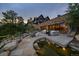 Expansive stone patio with pond offers an inviting setting for gatherings with great outdoor views at 34650 Sleeping Fox Trl, Evergreen, CO 80439