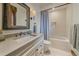 Neutral bathroom with a soaking tub, shower, and a large vanity with a stone countertop at 34650 Sleeping Fox Trl, Evergreen, CO 80439