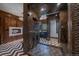 Luxurious bathroom with a glass shower, modern fireplace, and chevron patterned floors at 34650 Sleeping Fox Trl, Evergreen, CO 80439