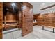 Luxurious spa featuring a steam sauna and adjoining bathroom, perfect for relaxation and wellness at 34650 Sleeping Fox Trl, Evergreen, CO 80439