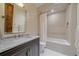 Bright bathroom featuring a marble countertop and tiled shower-tub, offering a clean and modern space at 34650 Sleeping Fox Trl, Evergreen, CO 80439