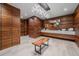 Stunning bathroom featuring elegant wood paneling, modern fixtures, and a unique wood slab bench at 34650 Sleeping Fox Trl, Evergreen, CO 80439