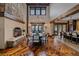Elegant dining room with stone fireplace, hardwood floors, and mountain views at 34650 Sleeping Fox Trl, Evergreen, CO 80439