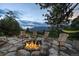 Picturesque stone fire pit area with Adirondack chairs, ideal for gatherings and enjoying nature at 34650 Sleeping Fox Trl, Evergreen, CO 80439