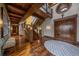 Grand foyer with custom wood staircase, designer lighting, and hardwood floors at 34650 Sleeping Fox Trl, Evergreen, CO 80439