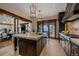 Stunning kitchen with a large marble island, stainless steel appliances, and access to an outdoor patio at 34650 Sleeping Fox Trl, Evergreen, CO 80439