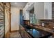 Modern kitchenette with sleek countertops, white cabinets, and rustic wood accents, offering style and functionality at 34650 Sleeping Fox Trl, Evergreen, CO 80439