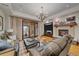 Spacious living room offers a fireplace, hardwood floors, comfortable seating, and access to a patio at 34650 Sleeping Fox Trl, Evergreen, CO 80439