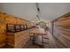 Stylish loft with wood paneled walls and floors, featuring dining area and comfortable lounge space at 34650 Sleeping Fox Trl, Evergreen, CO 80439